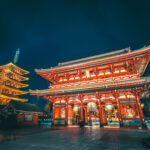 Night view of Senso-ji Temple and five-story pagoda in Tokyo, Japan, illuminated with golden lights