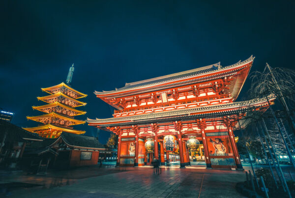 Night view of Senso-ji Temple and five-story pagoda in Tokyo, Japan, illuminated with golden lights