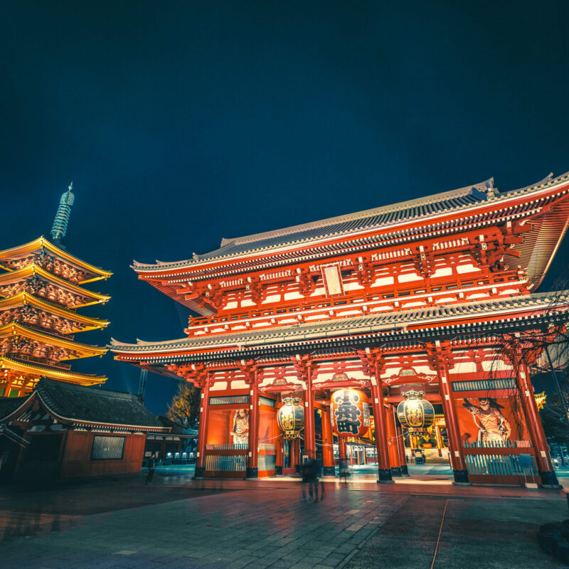 Night view of Senso-ji Temple and five-story pagoda in Tokyo, Japan, illuminated with golden lights